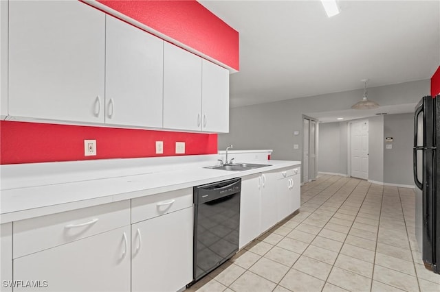 kitchen featuring white cabinetry, sink, light tile patterned floors, and black appliances