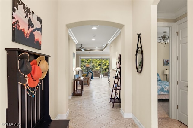 hallway with crown molding and light tile patterned flooring