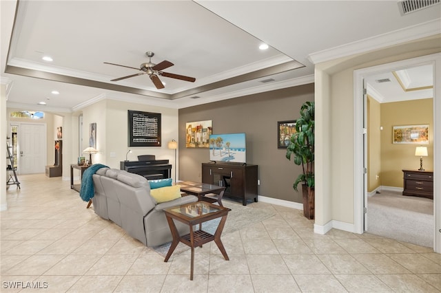 living area featuring a tray ceiling, visible vents, baseboards, and light tile patterned floors