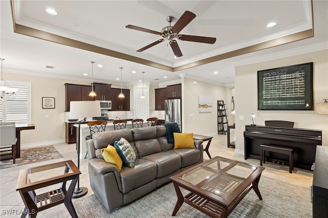 living area featuring recessed lighting, visible vents, baseboards, ornamental molding, and a raised ceiling