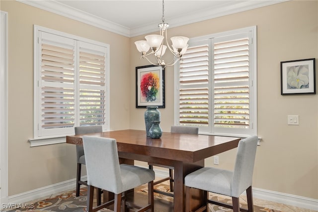 dining area with ornamental molding, baseboards, and an inviting chandelier