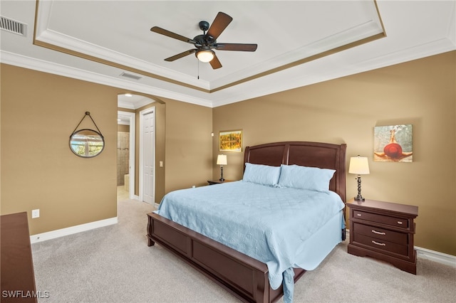 bedroom featuring carpet, visible vents, arched walkways, and a raised ceiling