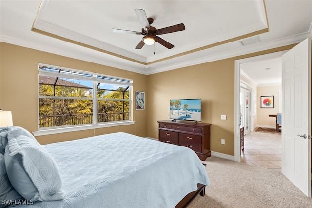 bedroom featuring baseboards, a tray ceiling, crown molding, and light colored carpet