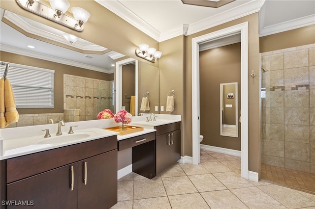 bathroom featuring toilet, vanity, tile patterned floors, a stall shower, and crown molding