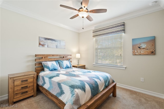 carpeted bedroom featuring baseboards, ceiling fan, and crown molding