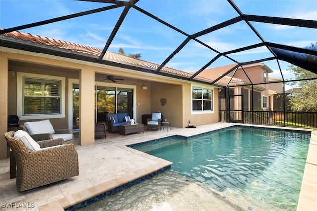 view of pool featuring ceiling fan, glass enclosure, an outdoor living space, a fenced in pool, and a patio area