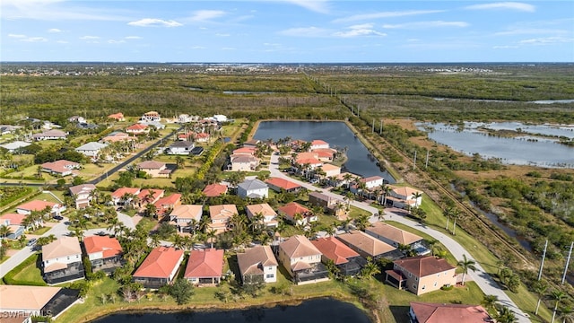 drone / aerial view featuring a residential view and a water view