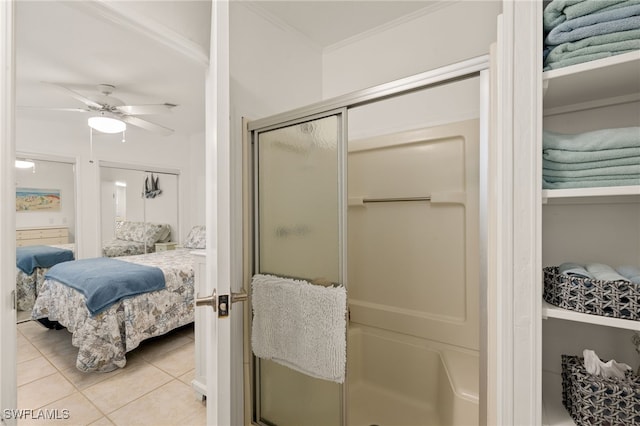 bathroom featuring ornamental molding, tile patterned floors, ceiling fan, and walk in shower