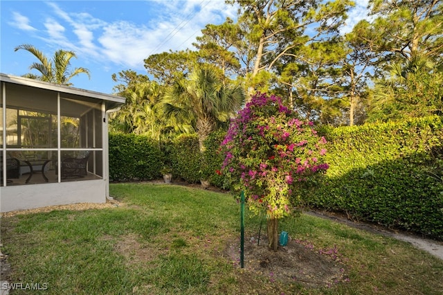 view of yard featuring a sunroom