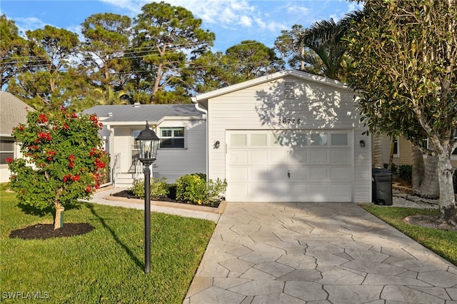 view of front of property with a garage and a front lawn