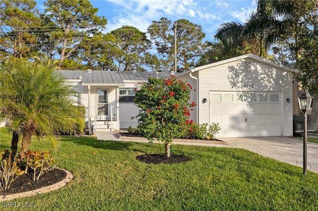 ranch-style home with a garage and a front lawn