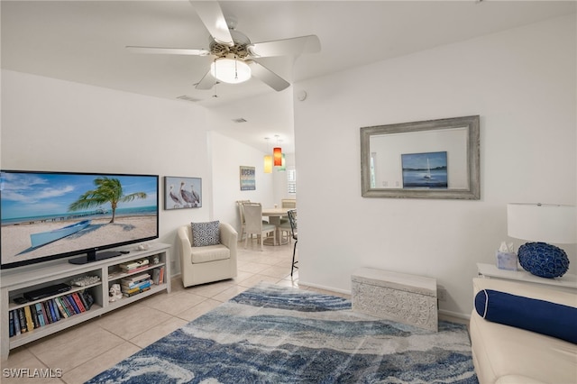 living room with vaulted ceiling, ceiling fan, and light tile patterned flooring