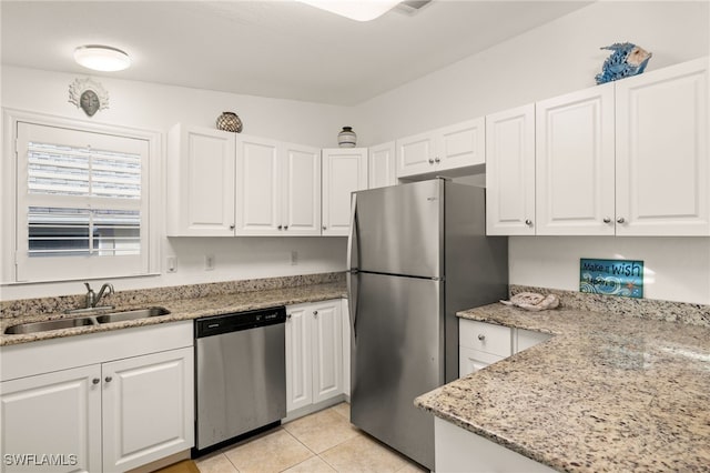 kitchen featuring white cabinetry, sink, light stone counters, and stainless steel appliances