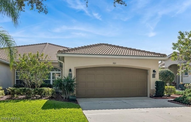 mediterranean / spanish-style house with a garage and a front yard