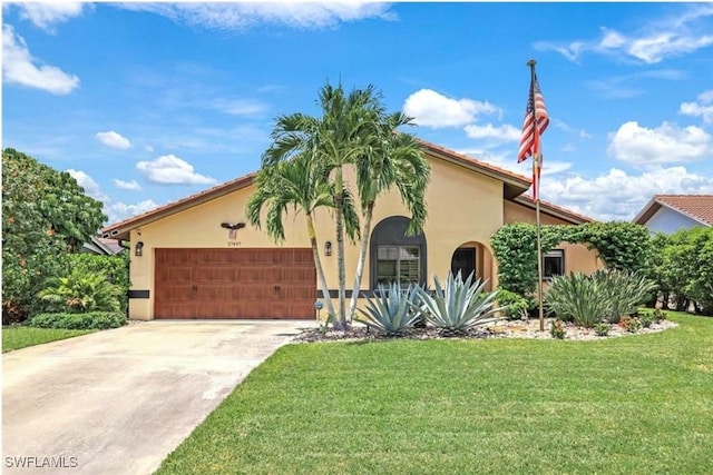 mediterranean / spanish house with a garage and a front yard