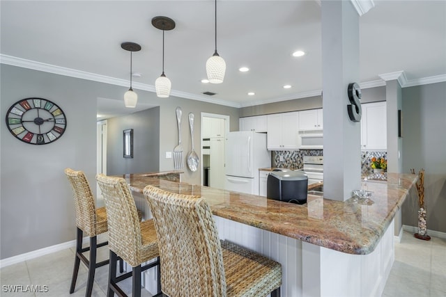 kitchen with white cabinetry, ornamental molding, white appliances, light stone counters, and pendant lighting