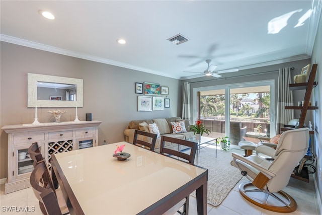 dining room with ornamental molding, light tile patterned flooring, and ceiling fan