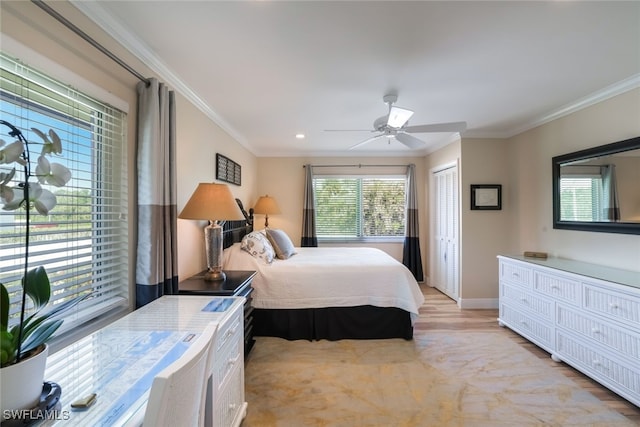 bedroom with light hardwood / wood-style floors, a closet, and ornamental molding