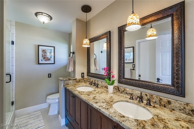 bathroom featuring tile patterned floors, toilet, vanity, and walk in shower