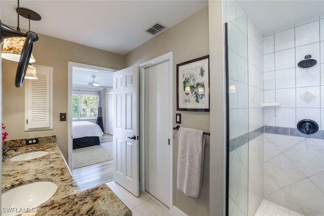 bathroom featuring tile patterned floors, vanity, and a shower with door