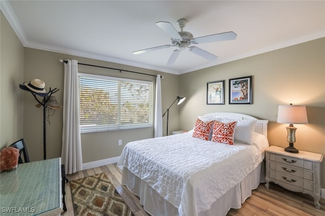 bedroom with light wood-type flooring, crown molding, and ceiling fan