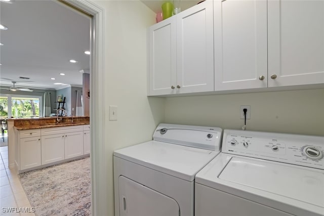 clothes washing area featuring light tile patterned floors, sink, separate washer and dryer, cabinets, and ceiling fan