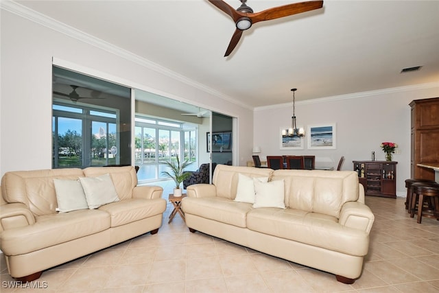 living room with ornamental molding, ceiling fan with notable chandelier, and light tile patterned flooring