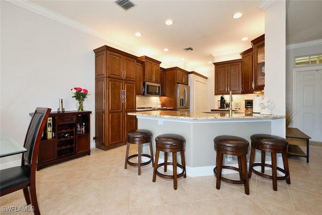 kitchen with ornamental molding, kitchen peninsula, stainless steel appliances, light stone countertops, and backsplash