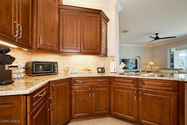 kitchen featuring light tile patterned flooring, ornamental molding, sink, and decorative backsplash