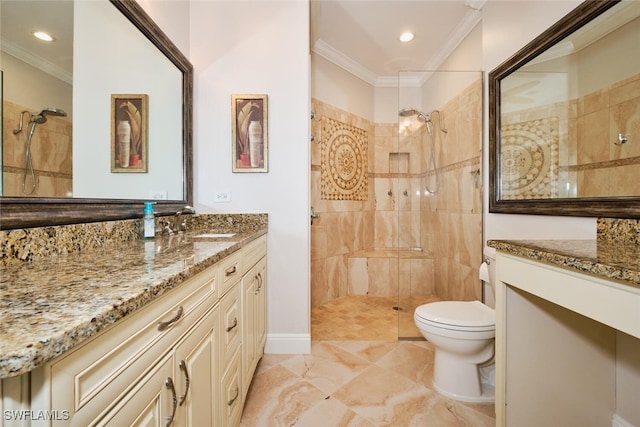 bathroom featuring toilet, ornamental molding, vanity, and tiled shower