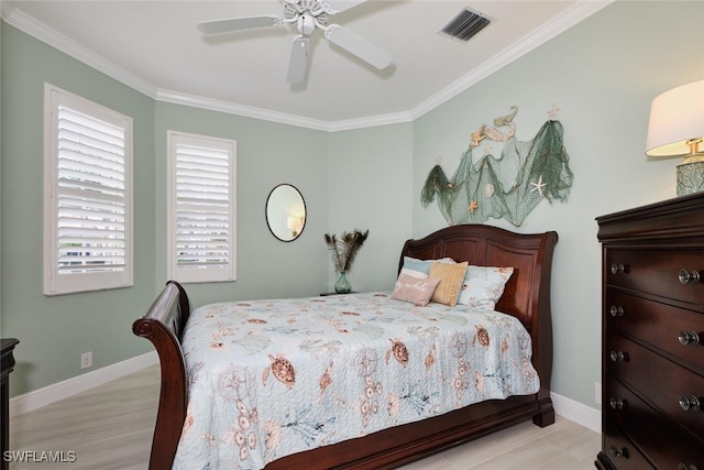 bedroom featuring ceiling fan, ornamental molding, and light wood-type flooring