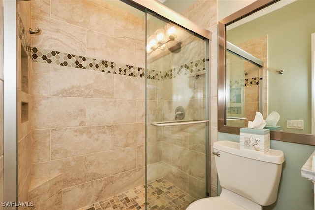 bathroom featuring walk in shower and toilet