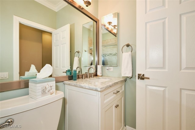 bathroom featuring vanity, crown molding, and toilet