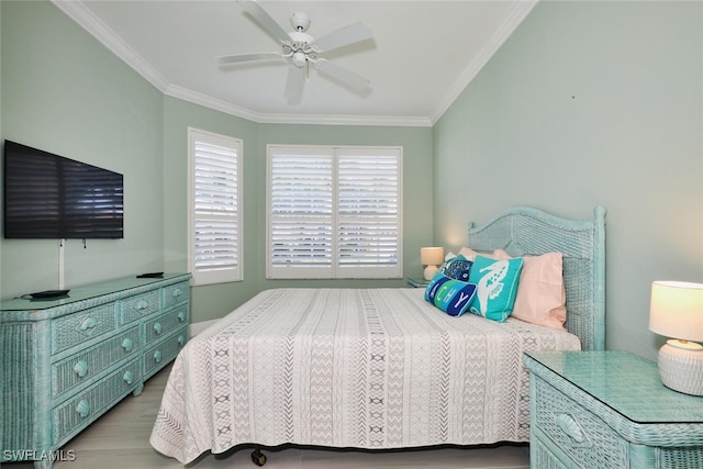 bedroom with ornamental molding, ceiling fan, and light hardwood / wood-style floors