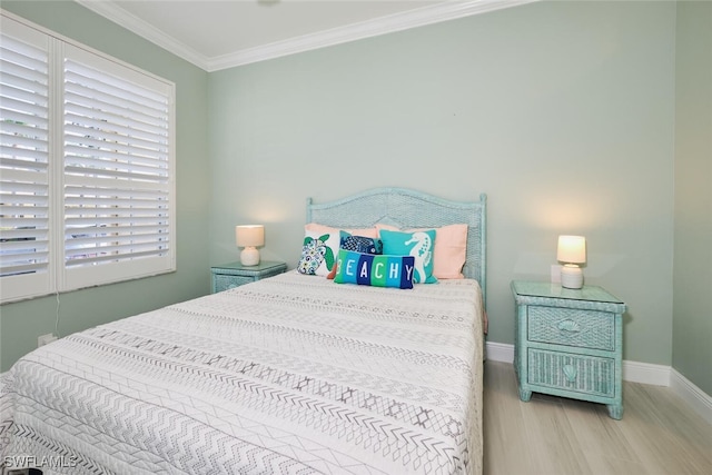 bedroom featuring crown molding, multiple windows, and light hardwood / wood-style flooring