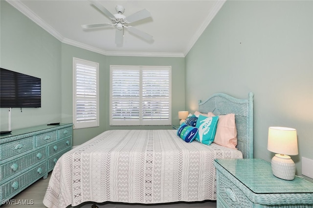 bedroom with ornamental molding, wood-type flooring, and ceiling fan