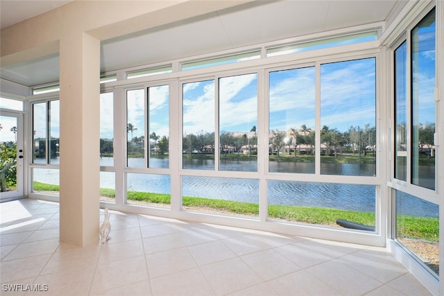 unfurnished sunroom featuring a water view and a wealth of natural light