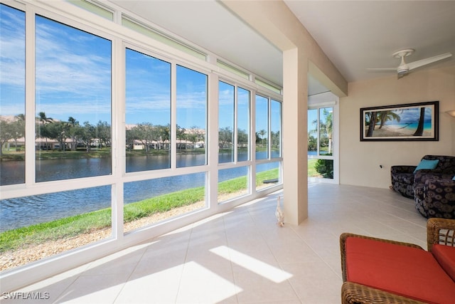 unfurnished sunroom with a water view, a healthy amount of sunlight, and ceiling fan