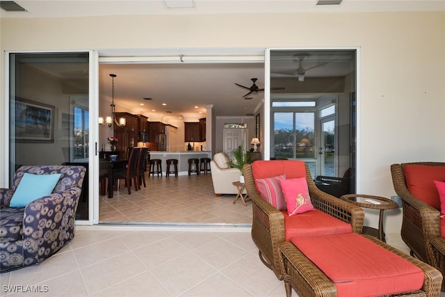 tiled living room featuring ceiling fan