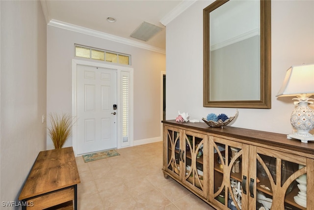 tiled foyer featuring crown molding