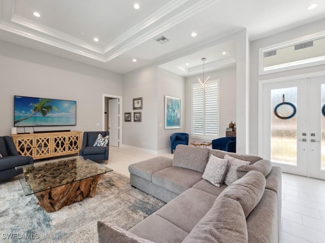 living area featuring ornamental molding, french doors, light tile patterned flooring, and a raised ceiling