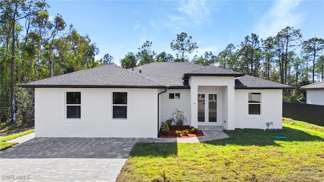 view of front of home featuring a front yard and french doors