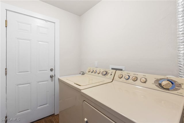 washroom featuring dark hardwood / wood-style flooring and separate washer and dryer