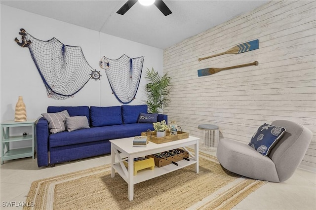 tiled living room with ceiling fan