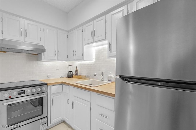 kitchen with white cabinetry, appliances with stainless steel finishes, sink, and decorative backsplash