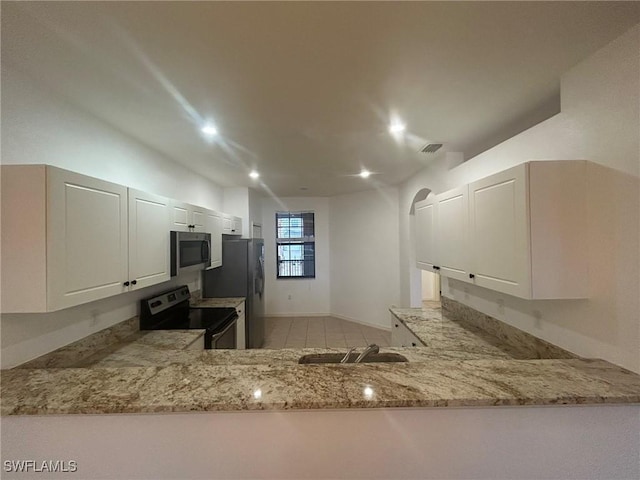 kitchen with sink, white cabinetry, stainless steel appliances, light stone counters, and kitchen peninsula