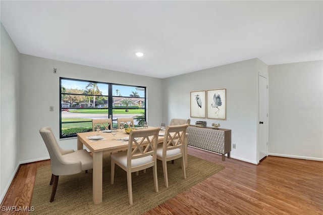 dining area with hardwood / wood-style flooring