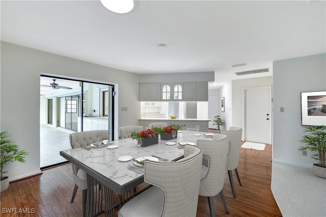 dining area with plenty of natural light and dark hardwood / wood-style floors