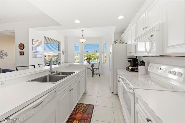 kitchen with sink, white cabinetry, light tile patterned floors, pendant lighting, and white appliances