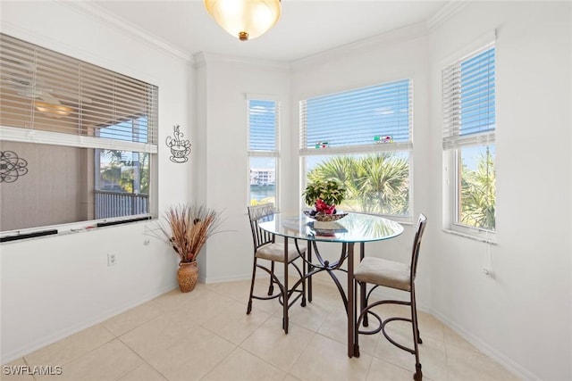 dining area with ornamental molding, plenty of natural light, and light tile patterned floors